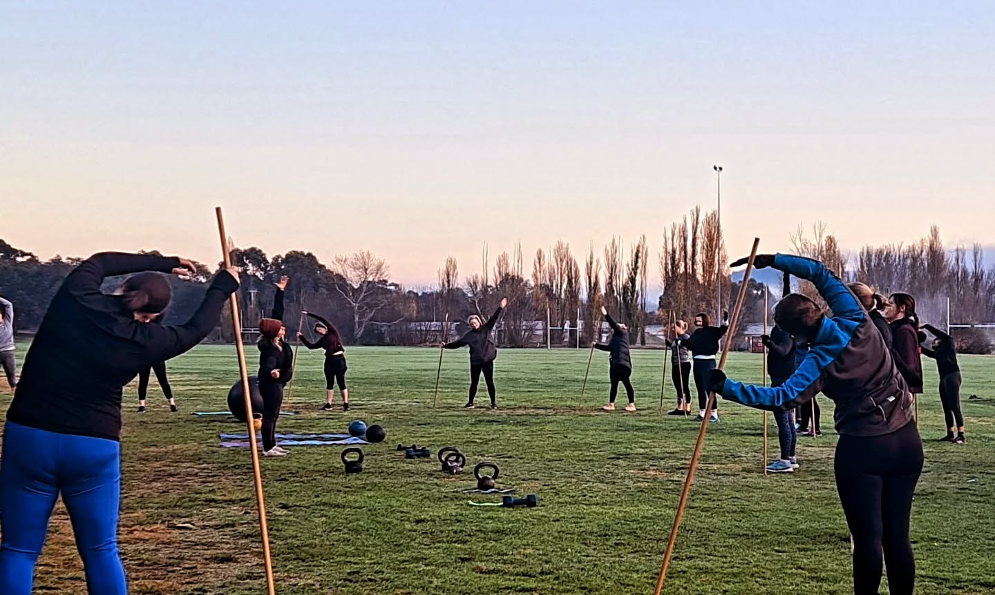 Women training together at sunrise in a group personal training session in Canberra